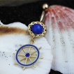 Piercing nombril plaqu� or et bleu � barre (roue) de bateau