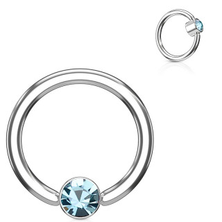 Anneau � cylindre captif serti d'un cristal bleu aqua
