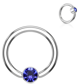 Anneau � cylindre captif serti d'un cristal bleu
